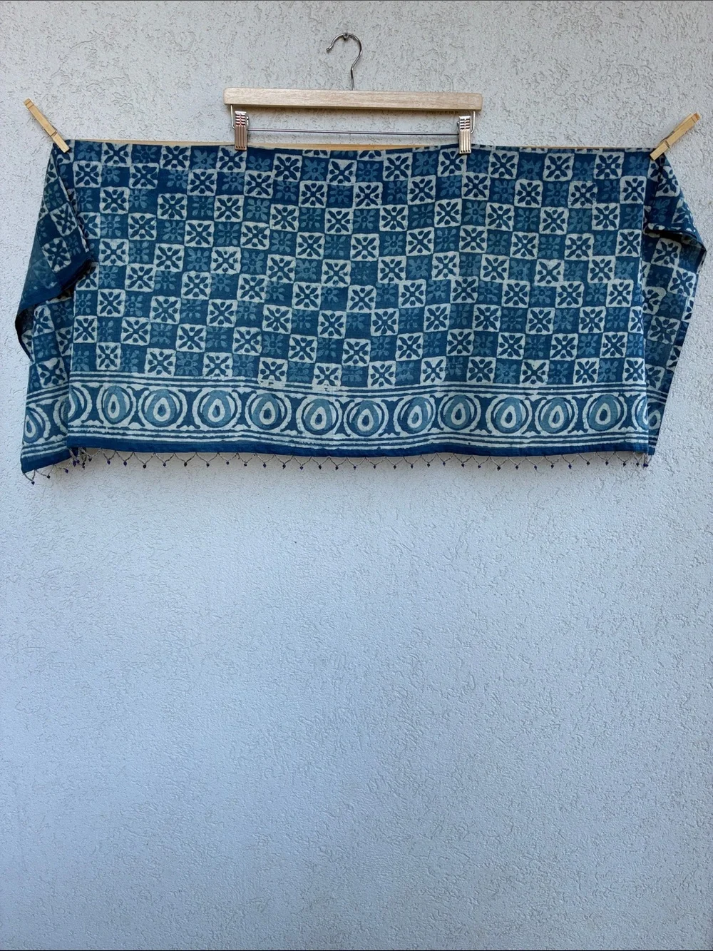 Blue & white  batik patterned short curtain or valance with beaded trim.